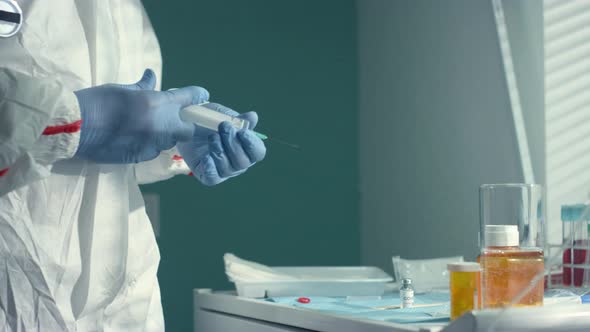 Doctor Fill Medical Syringe with Vaccine Fluid in Clinic Infectious Department