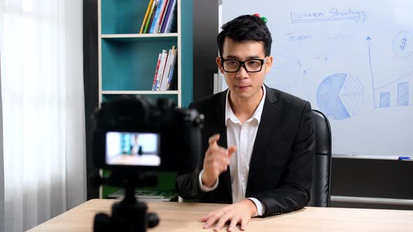 Asian Businessman Looking At Camera Talking About Company Strategy And Business Plan