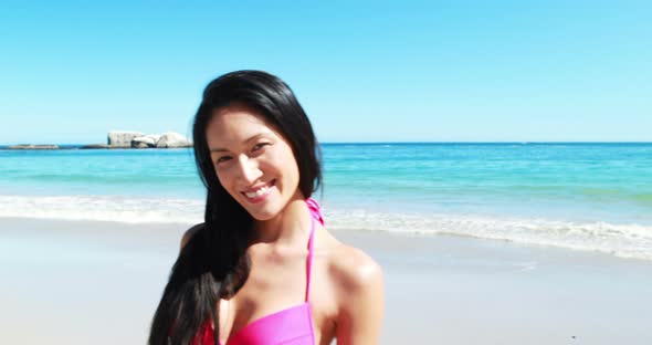 Beautiful young woman smiling on beach