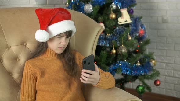 Teen Sitting in Decorated Living Room with Phone