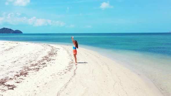 Girls enjoying life on marine resort beach journey by blue sea and white sand background of Thailand