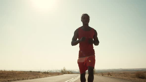 AfricanAmerican Man Runs Along Road Doing Daily Workout and Checks His Pulse on Smart Watch Front