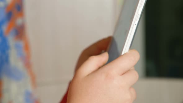 children with videogames addiction: child hands playing with digital tablet