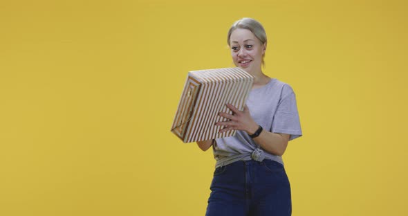 Young Woman Catching a Gift Box