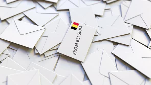 Envelope with From Belgium Text on Pile of Other Envelopes alt