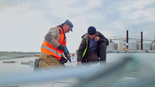 Technicians mounting solar panels. Installing alternative energy photovoltaic solar panels