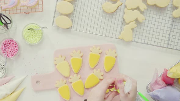 Step by step. Flat lay. Decorating Easter sugar cookies with royal icing.