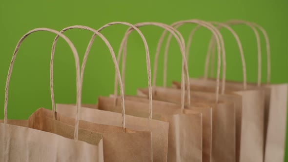 Paper package bags for shopping or delivery isolated on green background