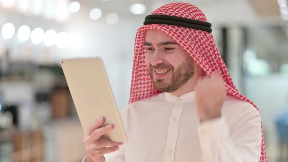 Portrait of Excited Businessman Celebrating Success on Tablet 