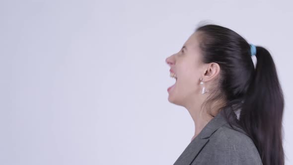 Closeup Profile View of Angry Young Businesswoman Shouting and Screaming