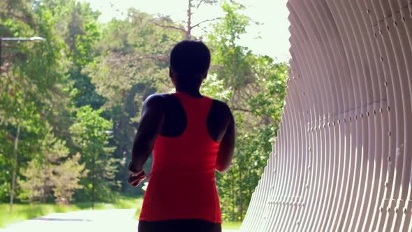 Young African American Woman Running in Tunnel