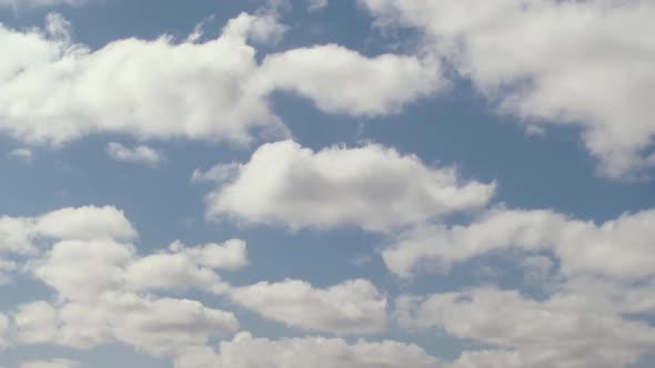 Blue sky with large clouds floating by.