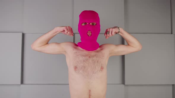 Anonymous Shirtless Man in Balaclava Showing Biceps