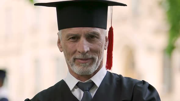 Confident middle-aged man graduating from university accessible education system