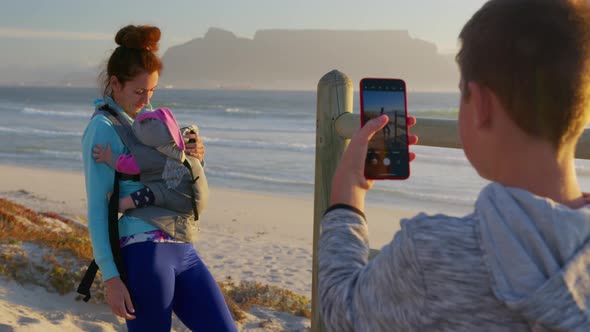 Son Photographs Mom and Child Against the Backdrop of the Table Mountain at Sunset South Africa