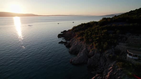 Aerial View of Landscape Sunset Over the Sea Leaves Trail and Glare on the Water