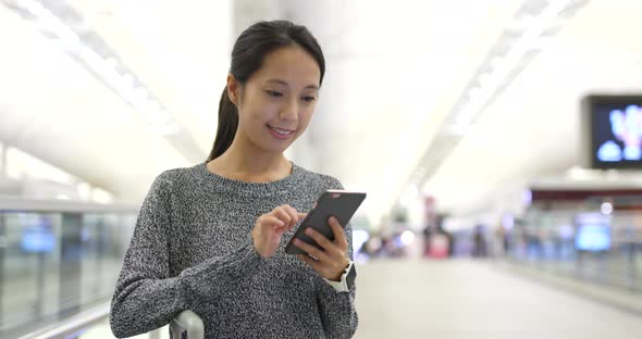 Woman use of mobile phone in airport 