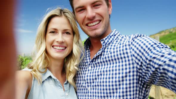 Portrait of happy couple enjoying in vineyard