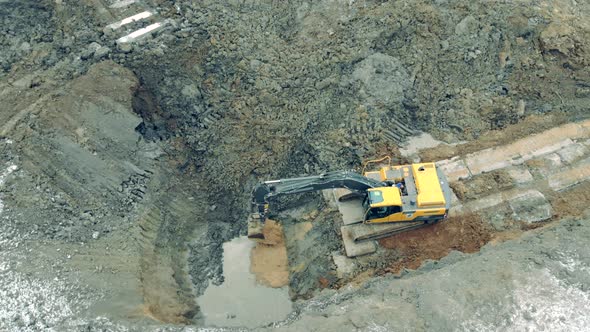 Excavator Is Pouring Sand Into the Quarry with Water