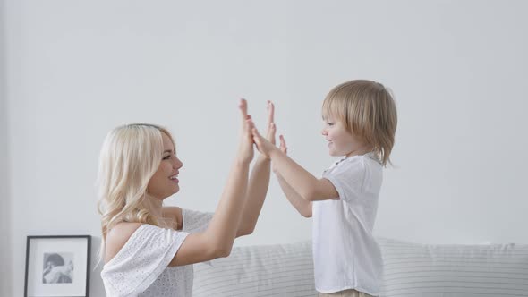 Happy Mother and Son Frolic in the Morning