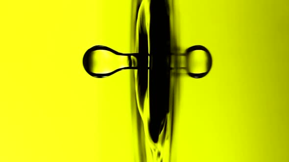 Vertical Video A Drop of Water Falls on the Surface of a Oil in Slow Motion