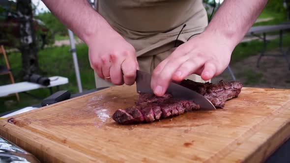 Slicing of juicy medium roast steak