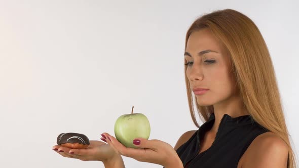 Young Woman Looking Confused Choosing Between Healthy and Junk Food