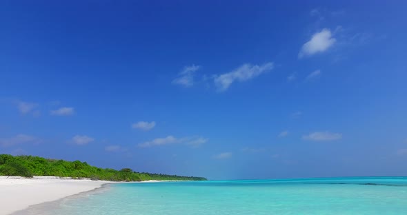 Daytime fly over copy space shot of a summer white paradise sand beach and aqua blue ocean background