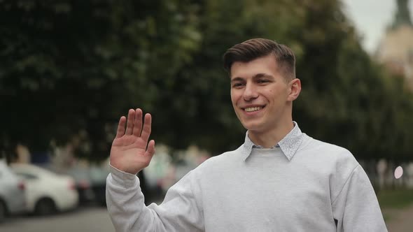 The Man is Waving to the Woman