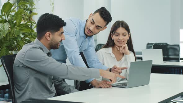 Multiethnic Business Team People Brainstorm Using Laptop Computer at Workplace
