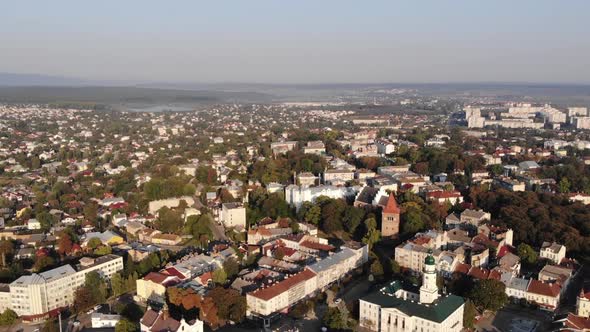 Aerial flyover above traditional european old town. Town hall, downtown, architecture. Zoom in 