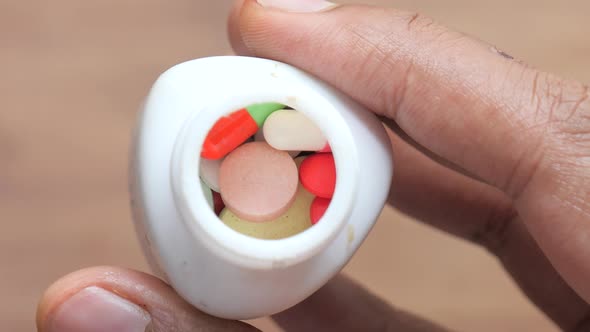 Close Up of Person Hand Holding Pill Container 