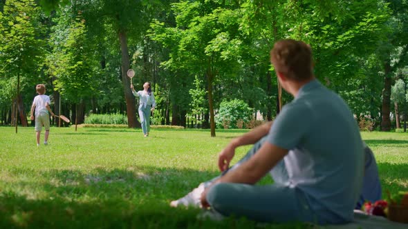 Young Father Watching Badminton Game Blurred View