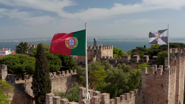 Close Up Aerial View of Portugal and Lisbon Flag Waving in the Wind on the Top of Castelo De S Jorge