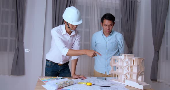 Two Business Men Or Engineers On An Architectural Model