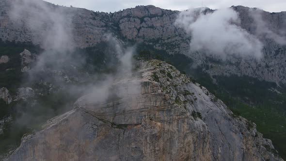 Rock ShaanKaya with Sheer Walls and Overgrown with Coniferous Forest Crimea