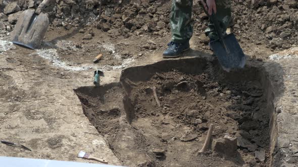 Young Archeologist Works on an Archaeological Site at Morning Sun Rays at Summer Heat