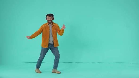 Cheerful Male in Headphones Moving to Music