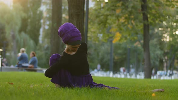Muslim Girl in Hijab Islamic Woman Female Yogi Sportswoman Practicing Yoga Workout in Park on Green