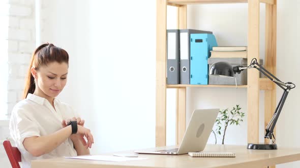 Woman Using Smart Watch in her Wrist