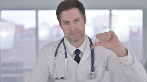 Portrait of Middle Aged Doctor Showing Thumbs Down