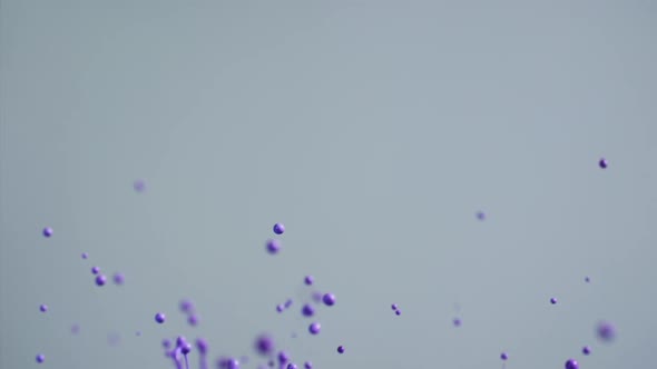 Purple Paint Flying Into Air Creating Abstract Patterns