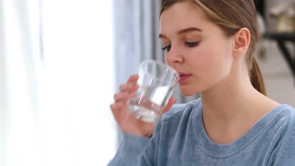 Beautiful Woman Drinking Water From Glass at Home