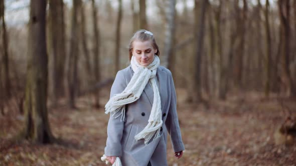 Portrait of Positive Woman Walking in Park in Autumn