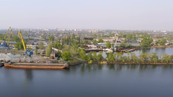 Port Cranes On A River Bank