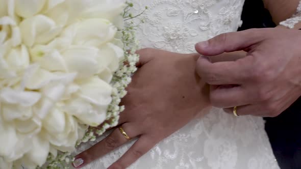 Groom caressing his bride on wedding day. Panoramic plane tilt up