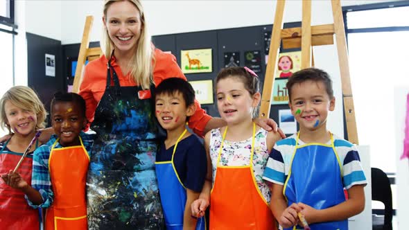 Teacher and schoolkid having fun in drawing class