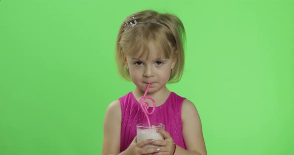 Happy Four Years Old Child in Pink Dress Drinks Milkshake Cocktail. Chroma Key