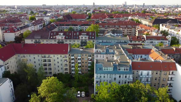 Two people enjoying the sun on the rooftops over Berlin.Fantastic aerial view flight sinking down d