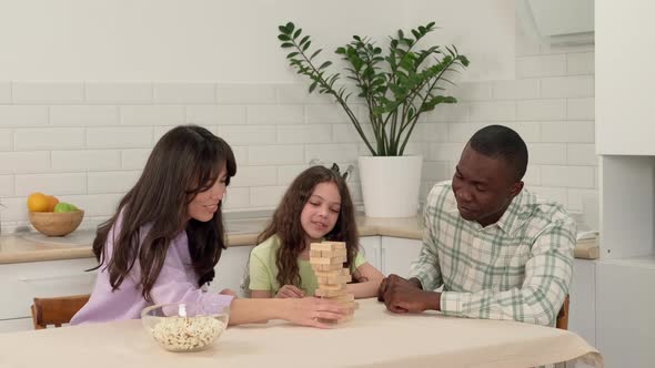 Happy Family of Different Races Play Board Game at Home